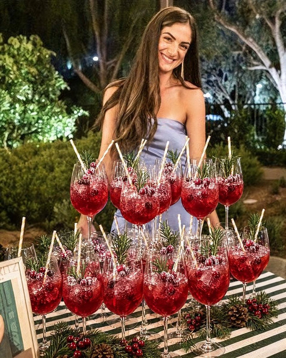 Guest behind a tower of spritz cocktails